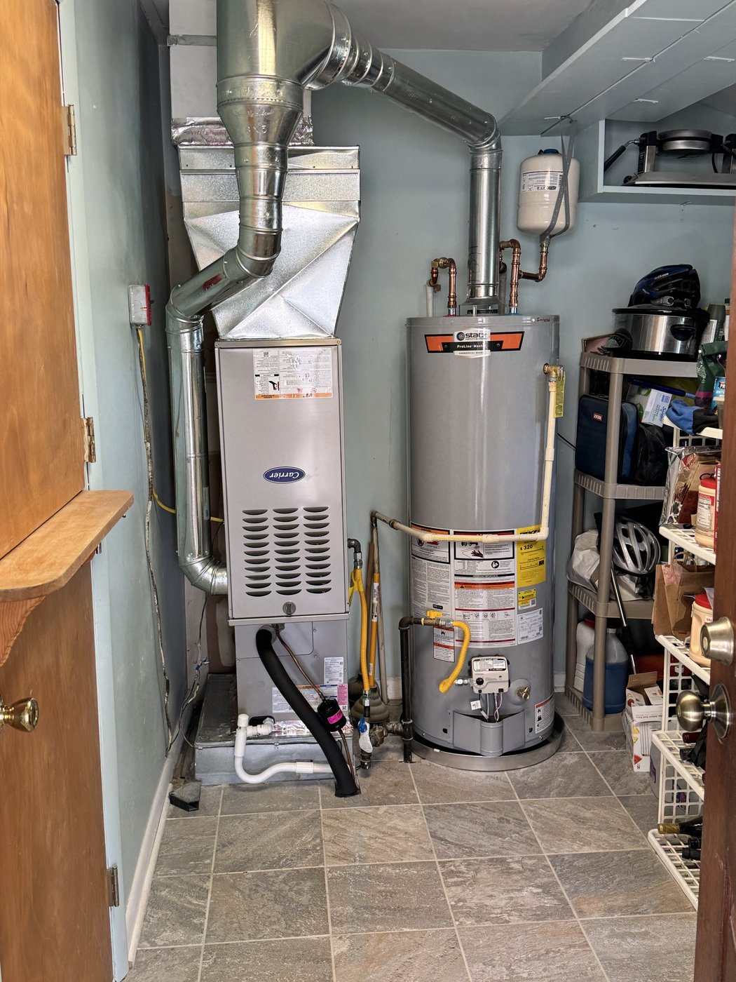Water heater installed alongside furnace system by Mercy's Plumbing